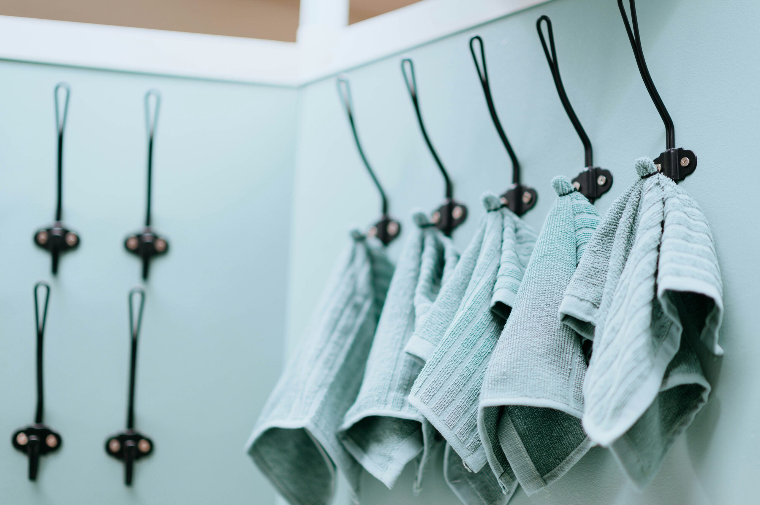 A messy wardrobe filled with clothes spilling out of drawers.