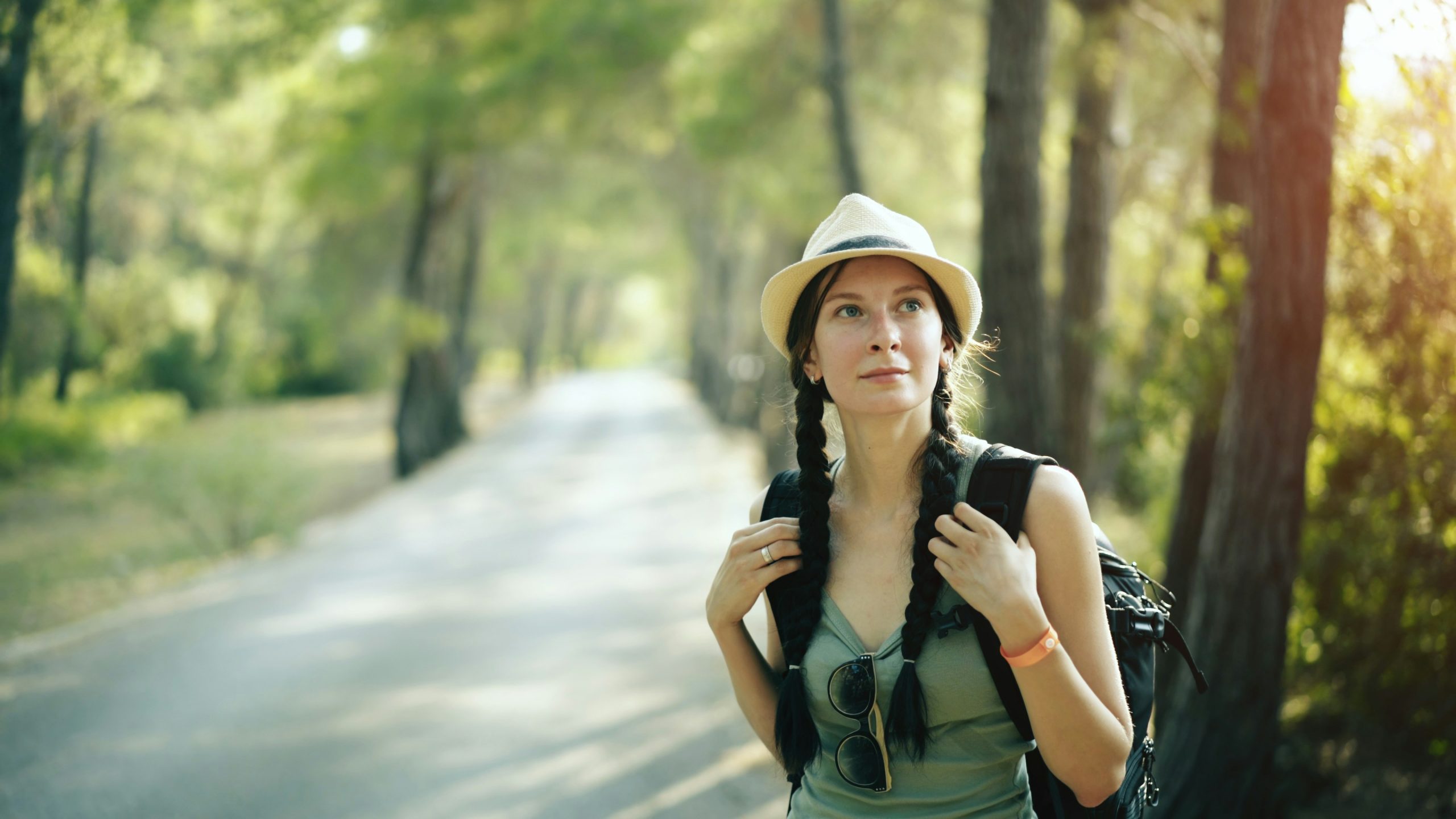Smiling woman wearing stylish athletic wear walking in nature