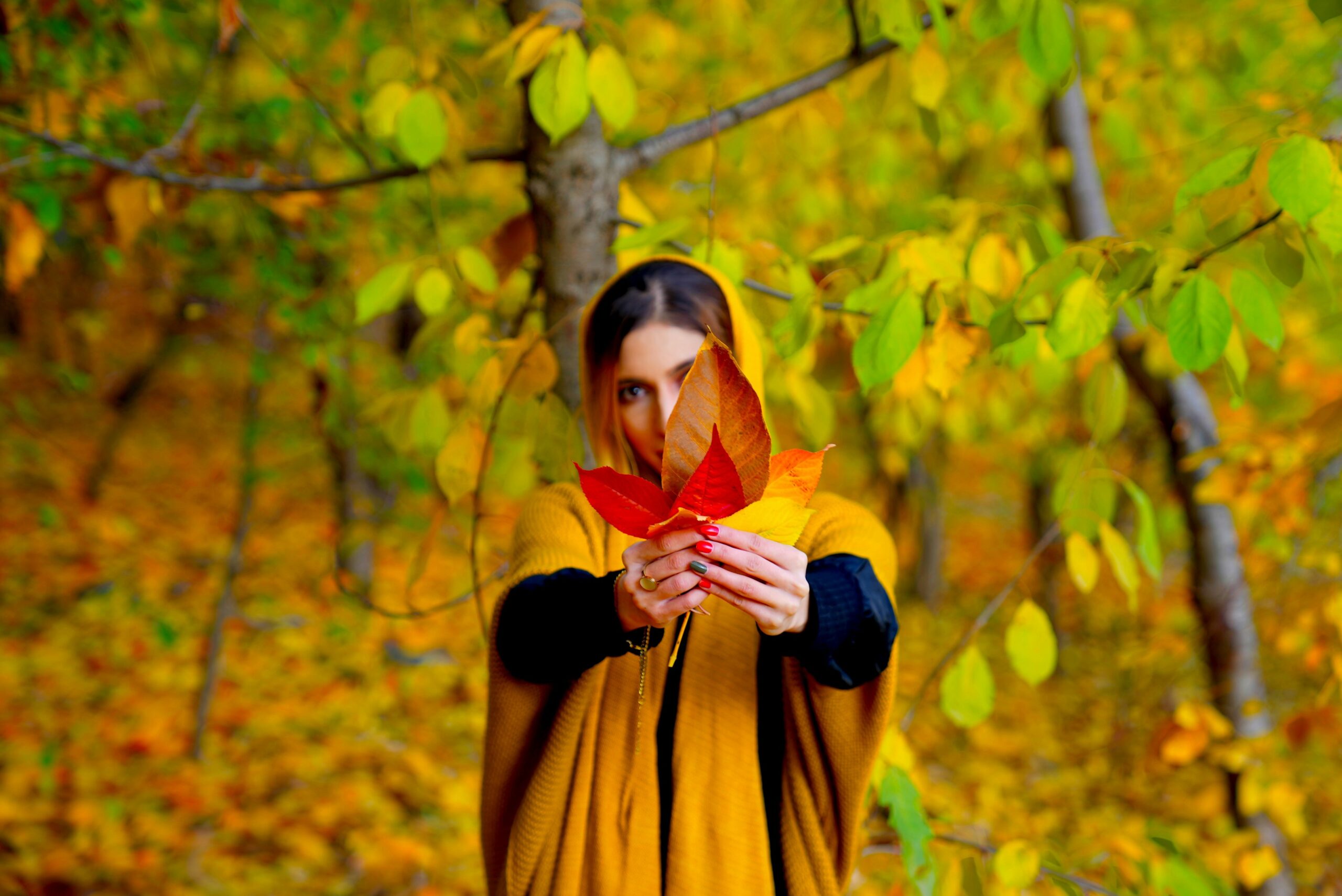 Woman in yoga attire paired with a stylish scarf, standing confidently
