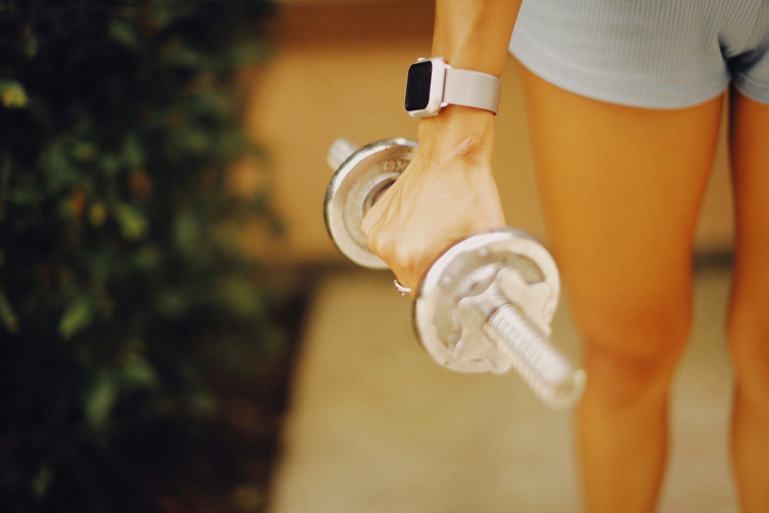 A model wearing a fitness tracker paired with stylish activewear