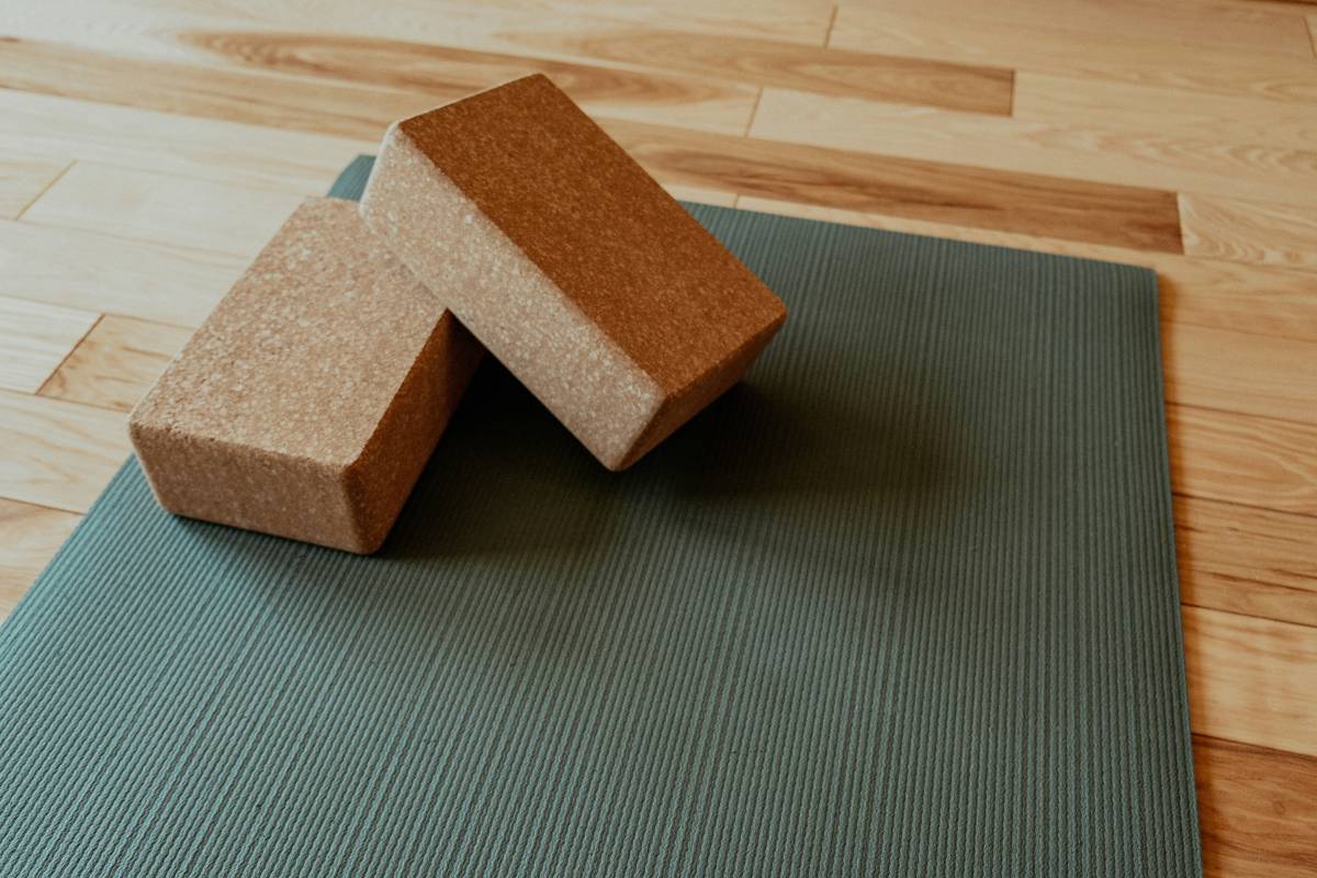 Woman meditating on a colorful yoga mat in her living room