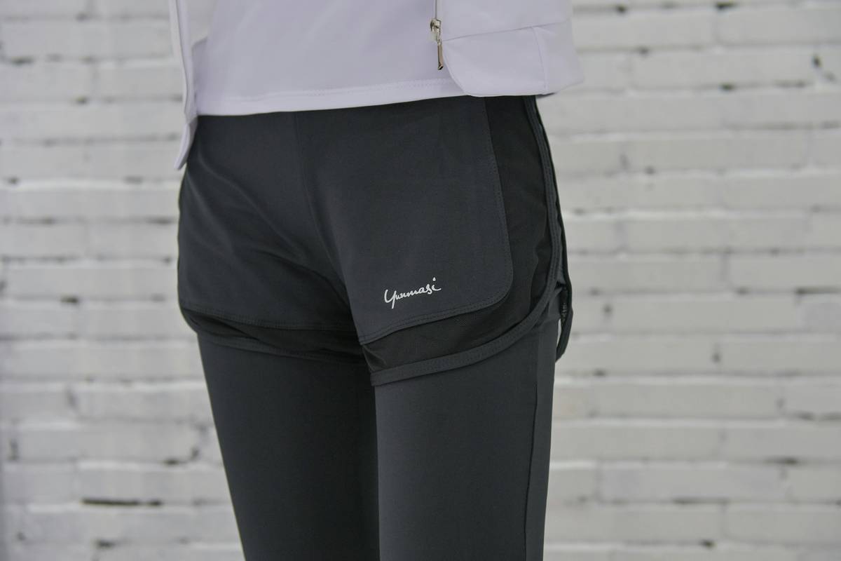 A model wearing Bloomingdale's athletic wear with accessories adding pops of color