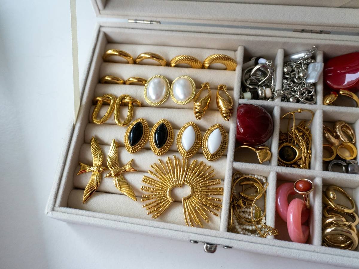 Before: chaotic drawer with tangled necklaces; After: Lacoste case with labeled sections, all items visible and separated