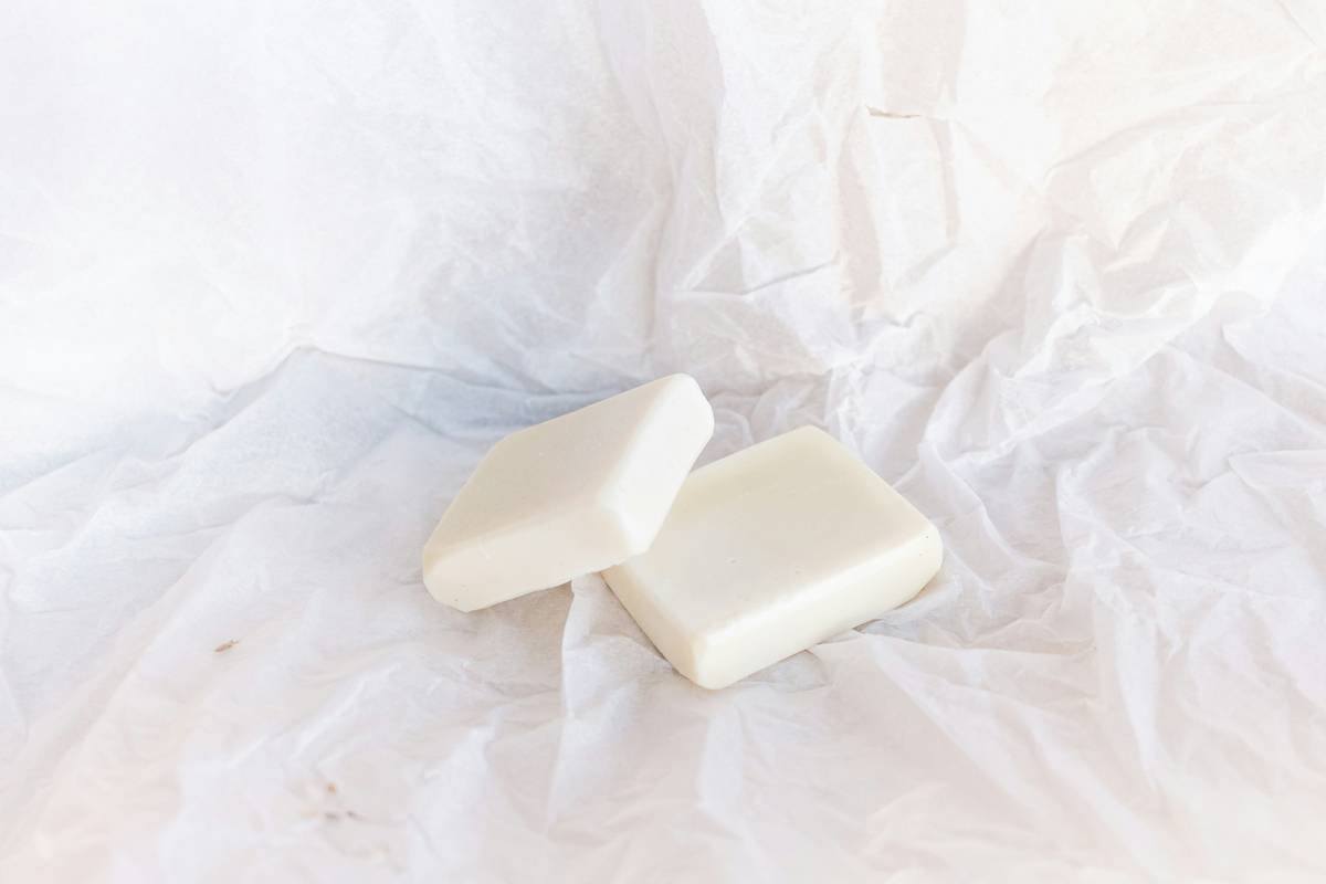 Bar chart comparing fabric degradation after 20 washes: conventional detergent vs. sustainable laundry soap. Sustainable option shows 85% fiber integrity retention vs. 55% with conventional.