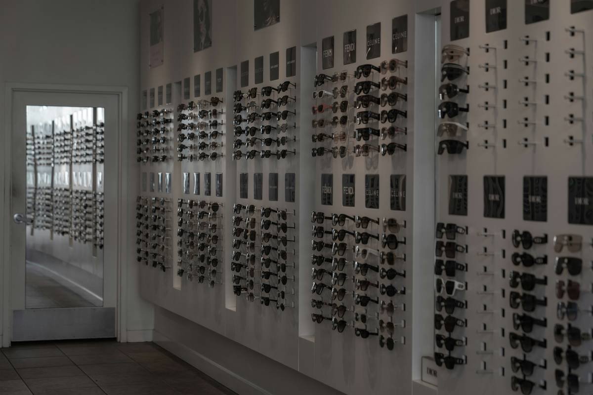 Hard-shell sunglasses case storage options lined up neatly on a dresser with Bloomingdale's shopping bag nearby